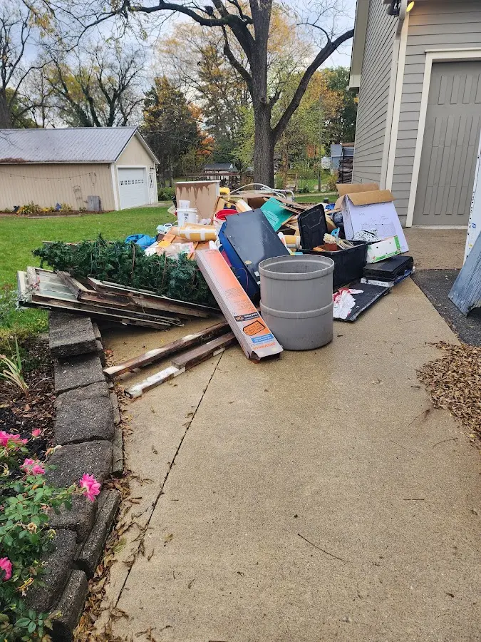 Dumpster being loaded with debris for Estate Cleanout Dumpster Rental in Flushing